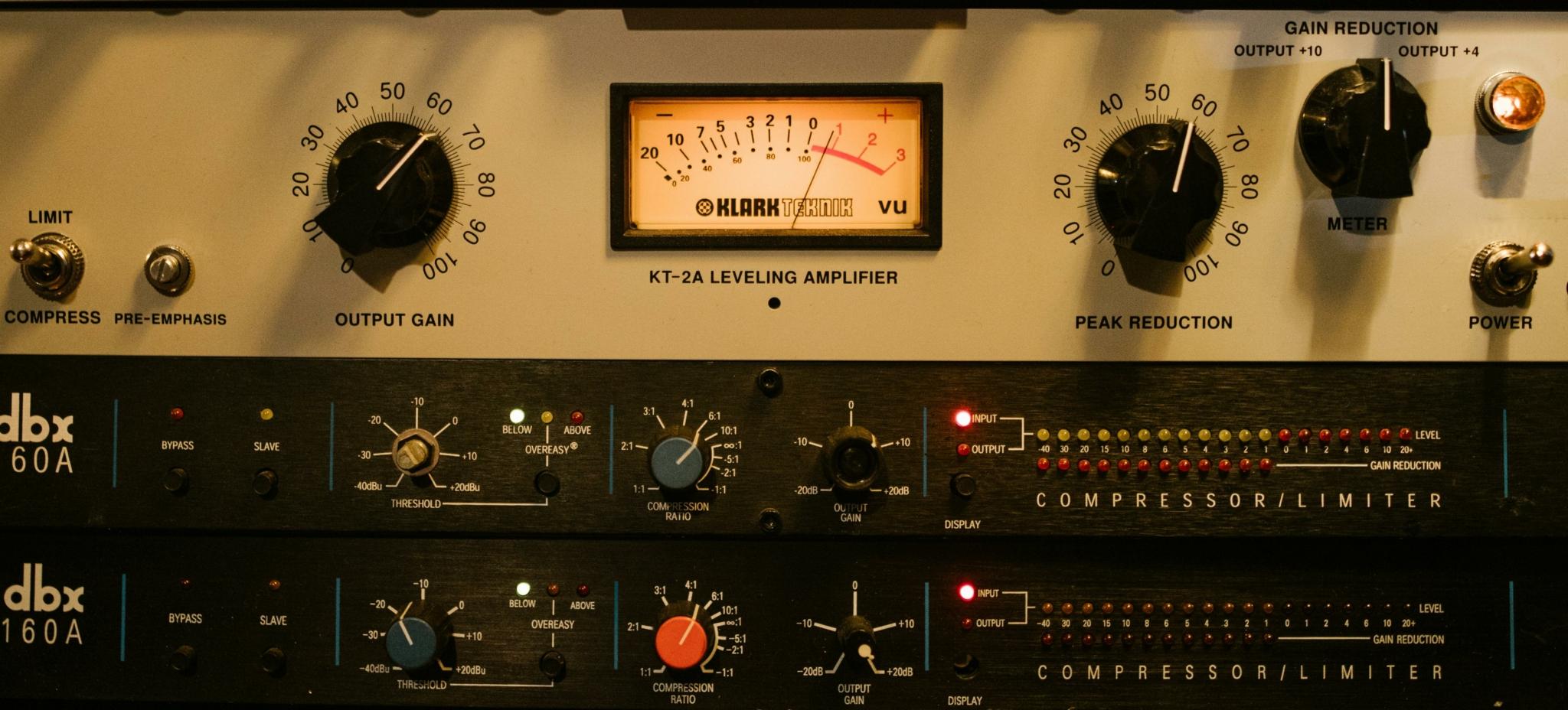 Professional audio equipment setup with leveling amplifier and compressor units.