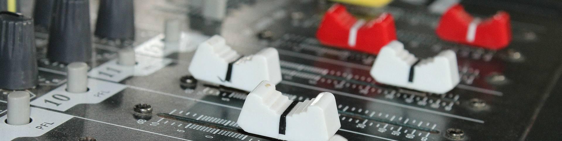 Faders on an analogue desk using for audio summing