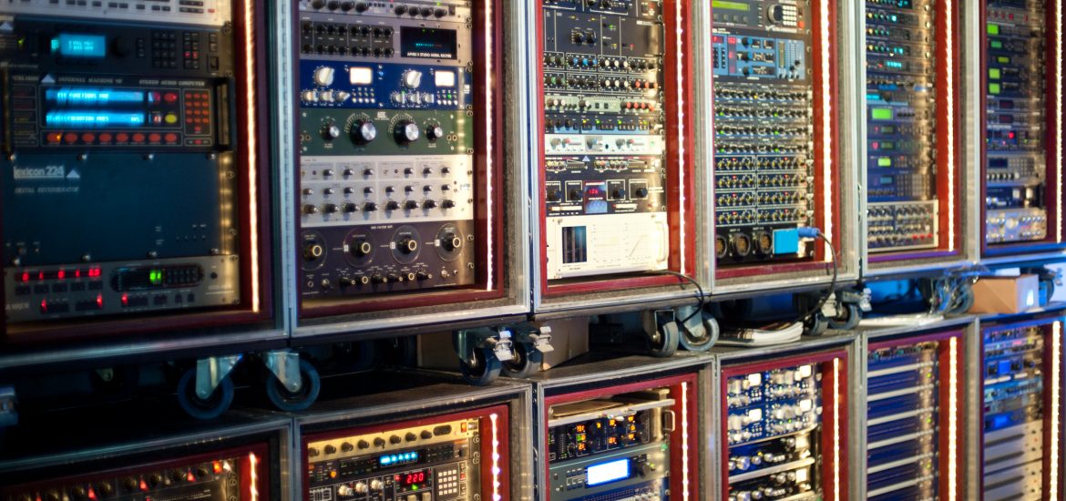 A series of patch bays full of preamp and other audio equipment