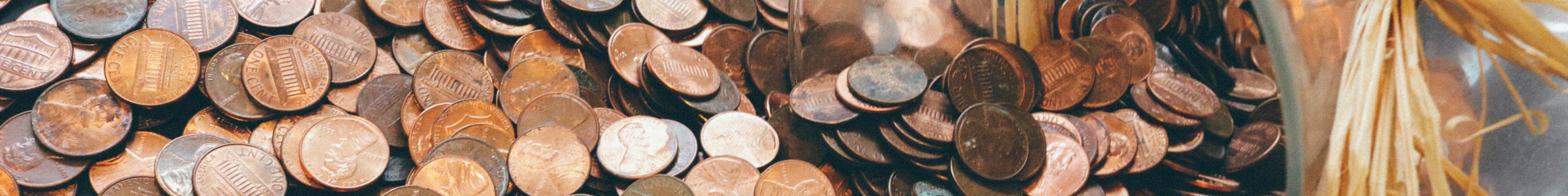 A pile of coins falling out of a jar