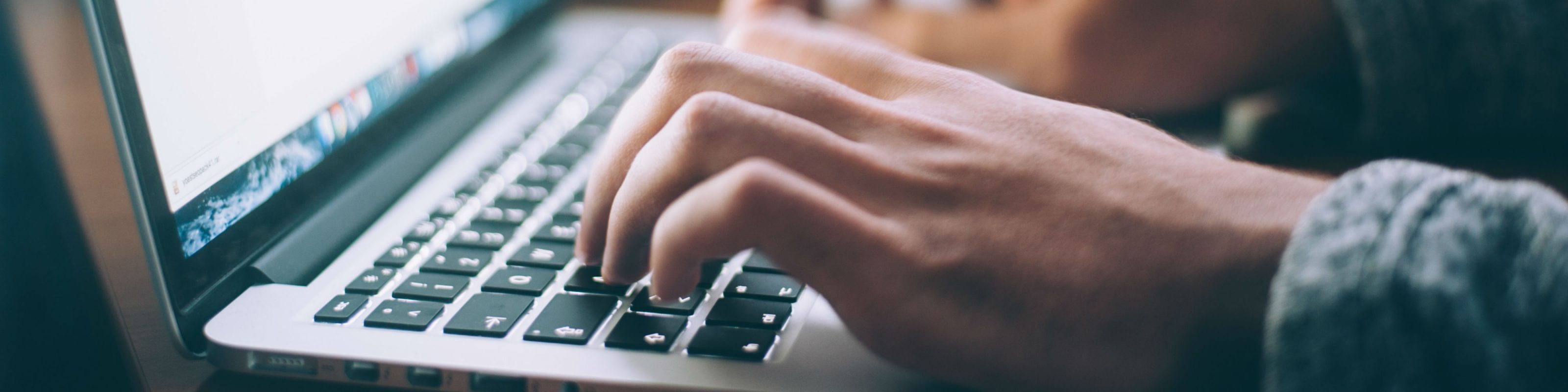 A person typing on a laptop