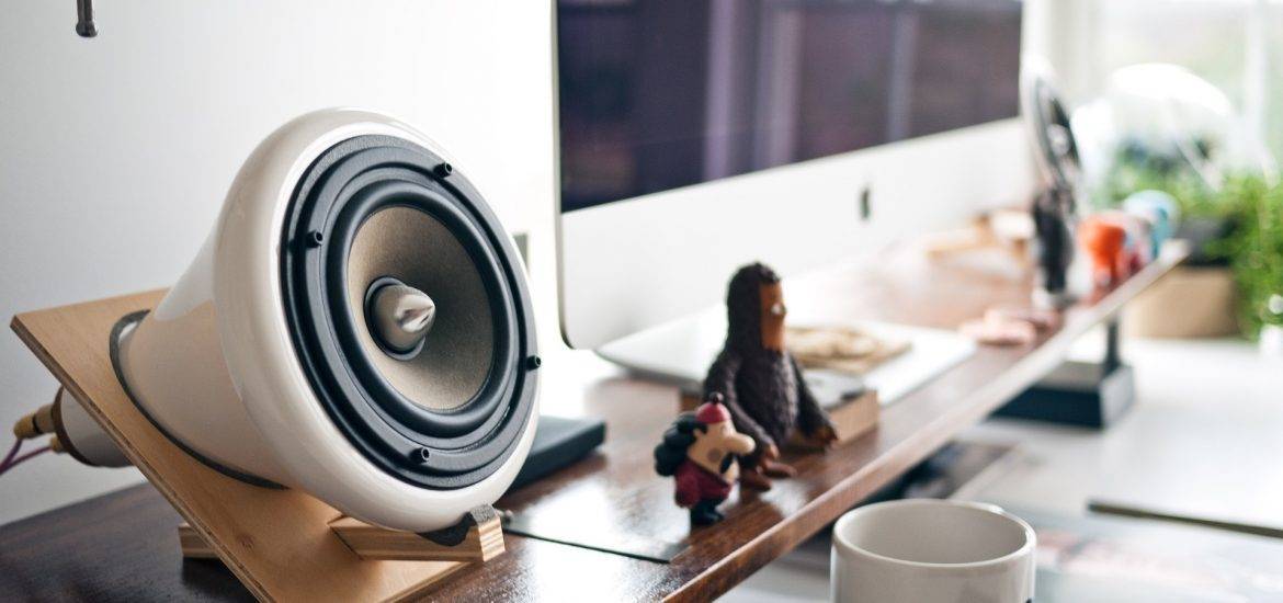 Desktop mounted small speakers for a PC