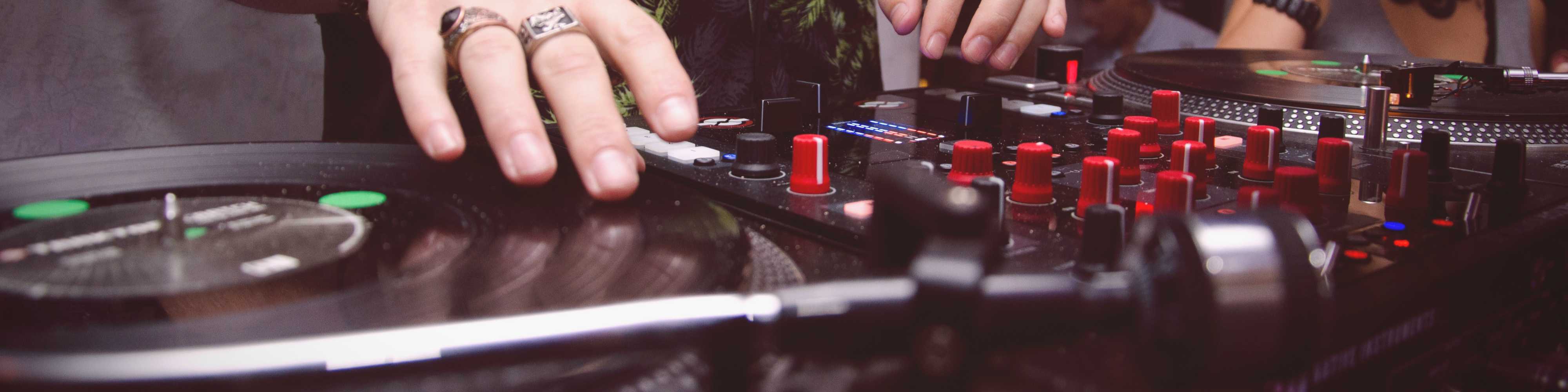 A man scratching on a turntable.