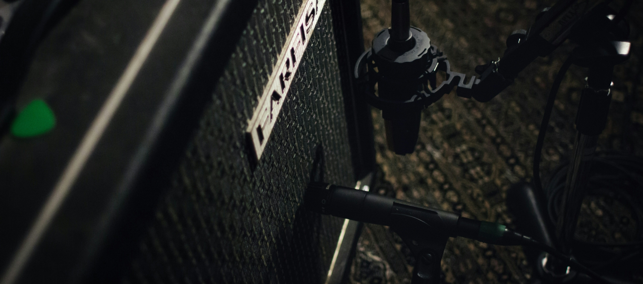 Close-up of a microphone setup near an amplifier