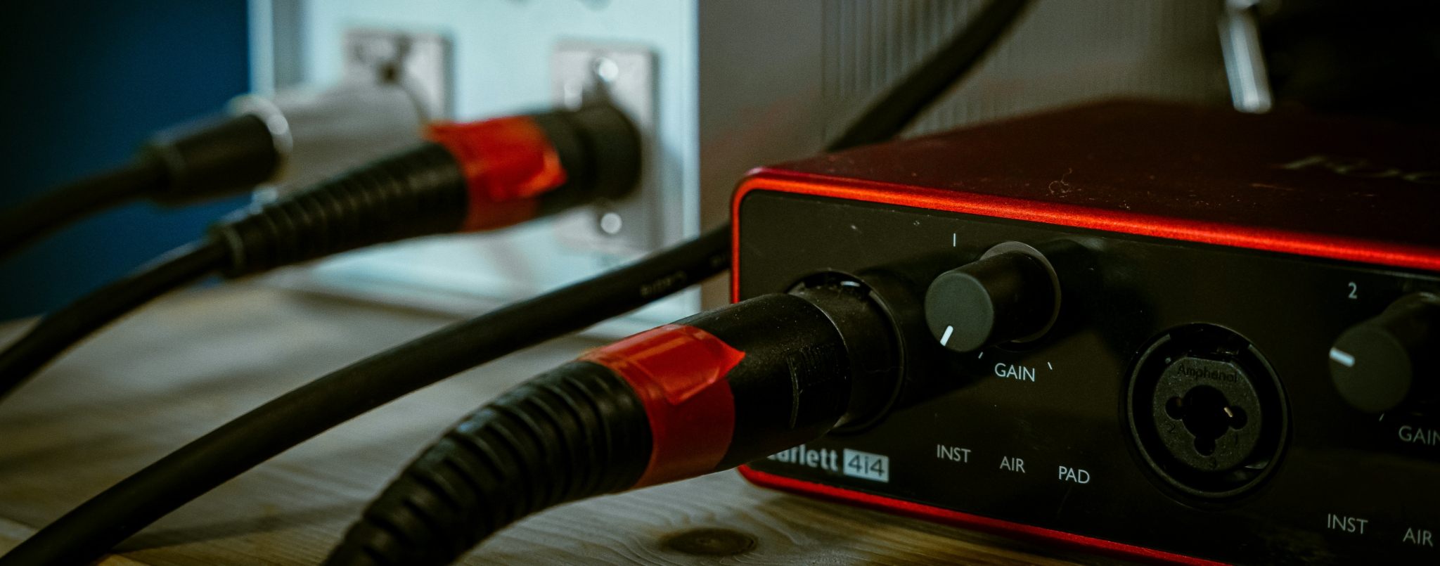 Audio interface and equipment showing Scarlett 414 with gain controls and audio cables.