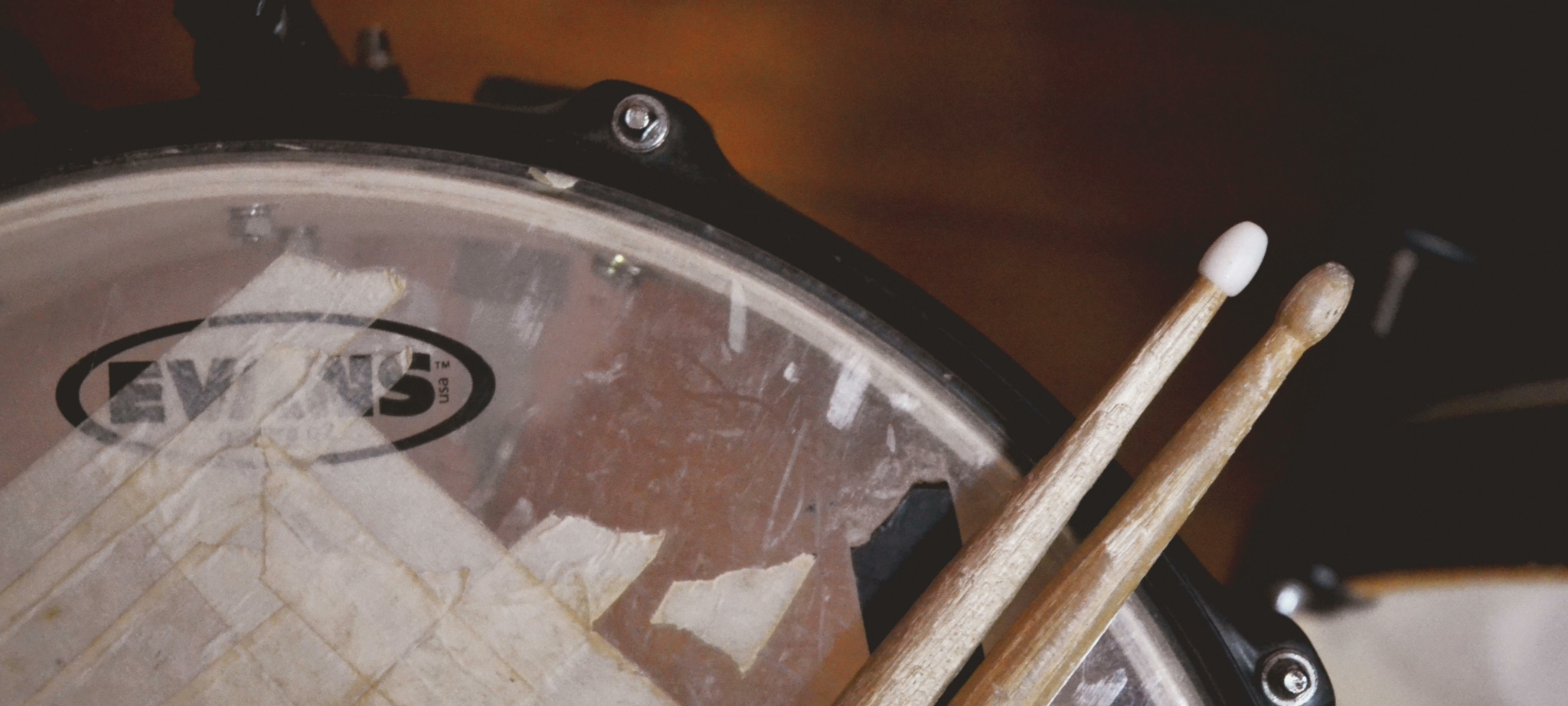 Close-up of a snare drum and drumsticks from drum kit