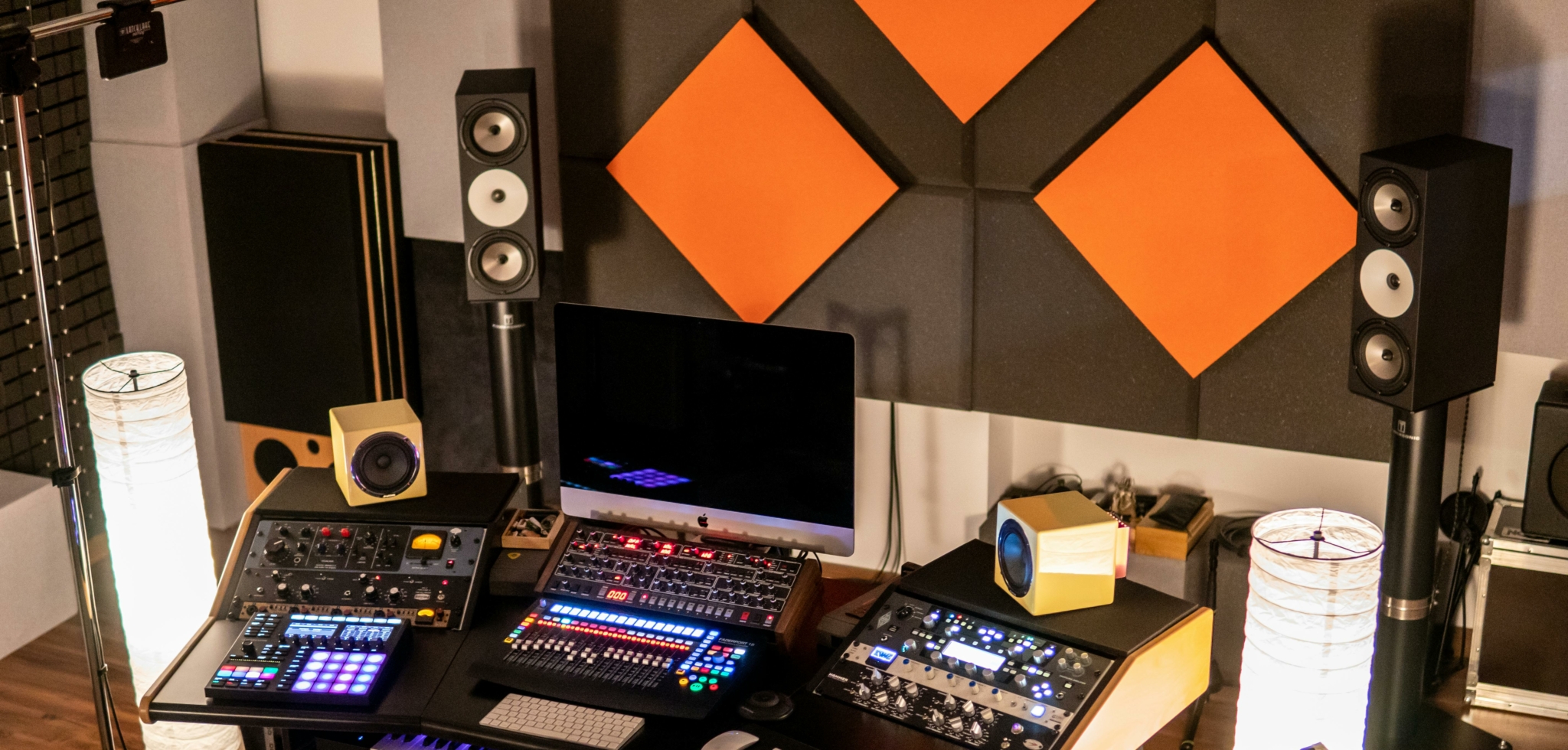 A well-equipped audio production studio with various monitors and absortion pannels