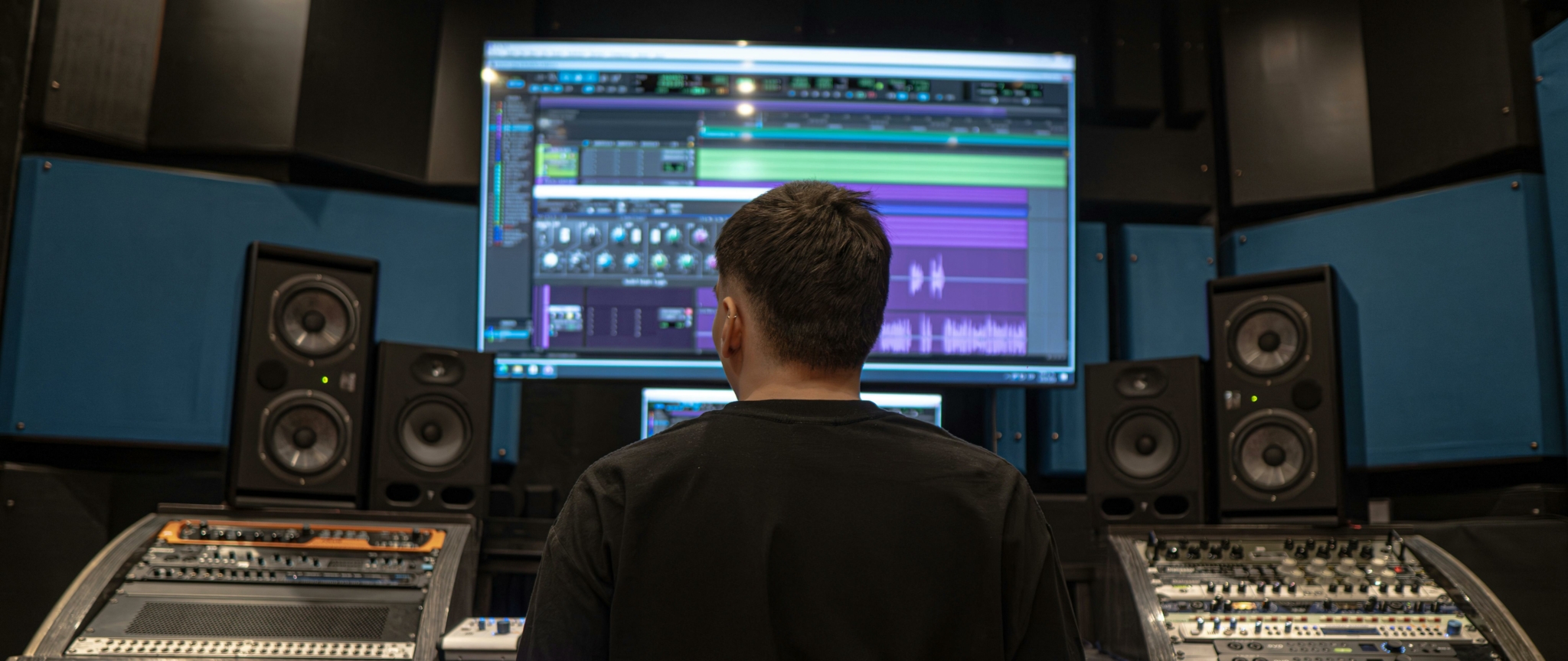 Audio production studio with a person mixing music