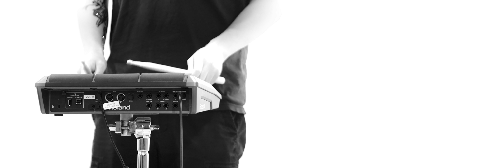 Musician playing a Roland electronic drum pad.