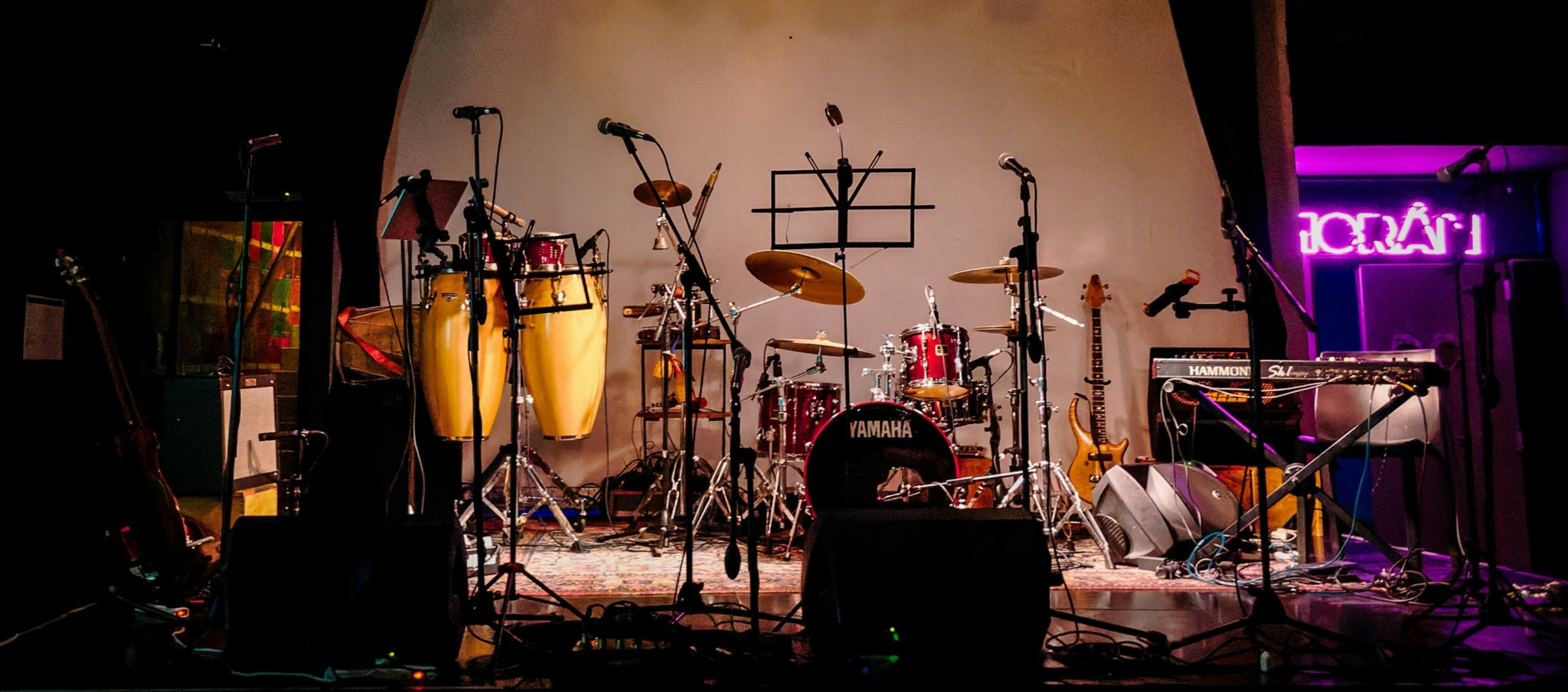 A stage setup with musical instruments and microphones.