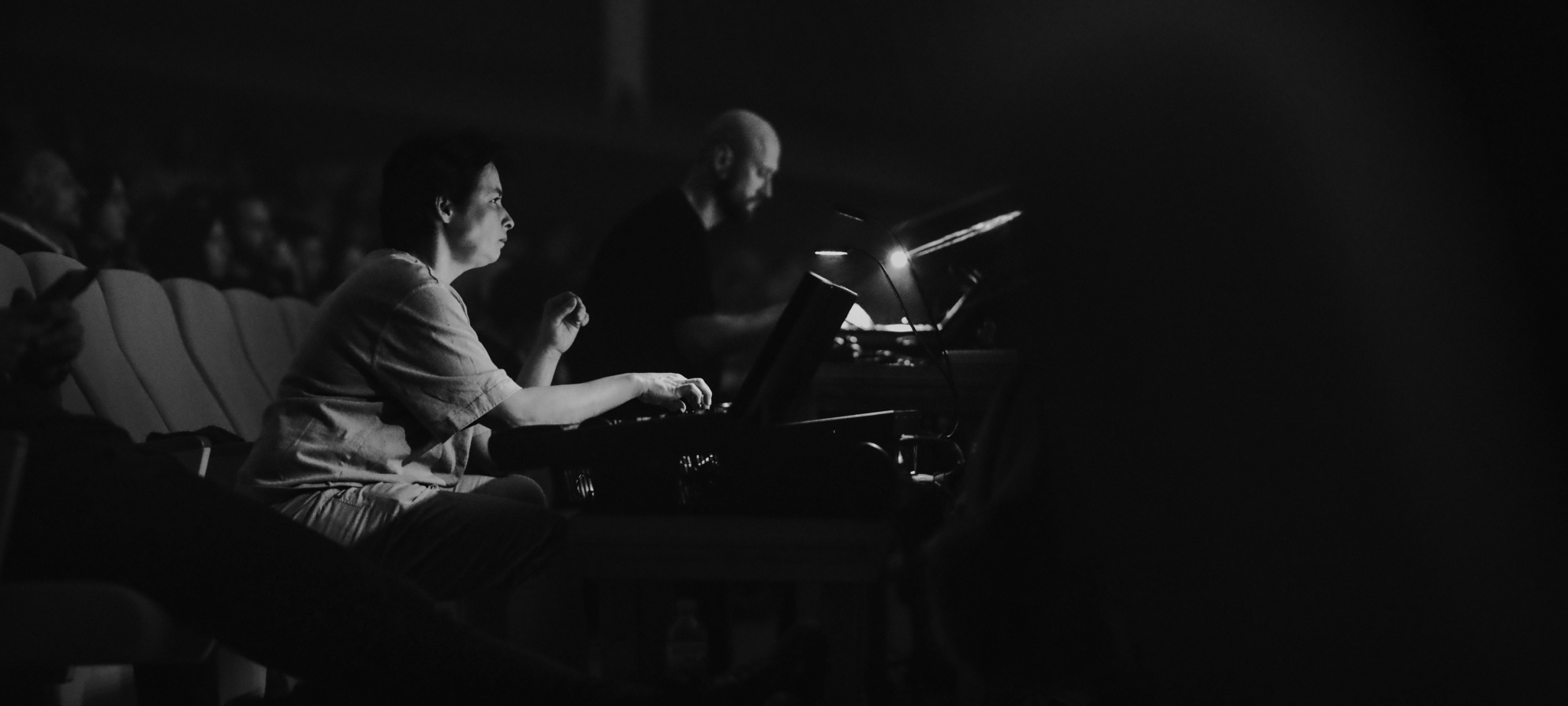 A sound engineer adjusting equipment during a live performance.