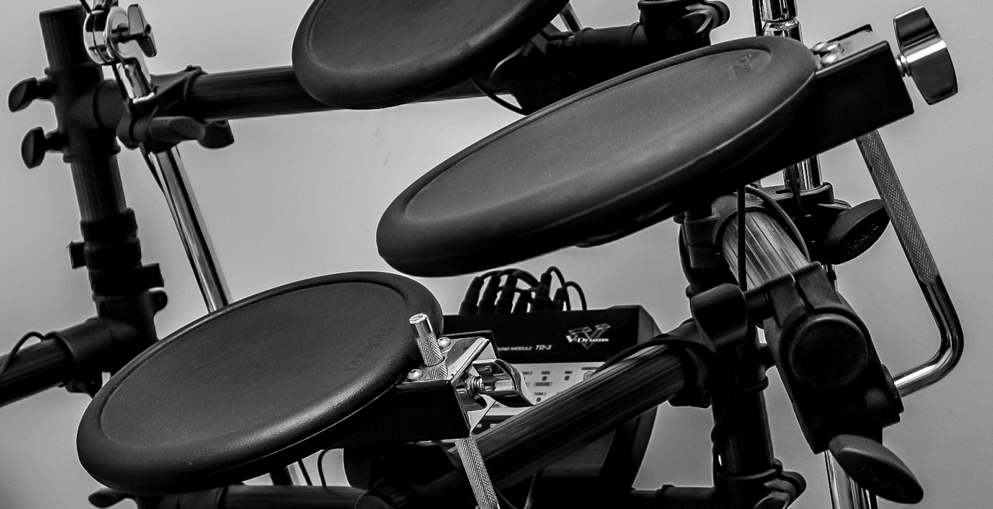 Close-up of an electronic drum kit featuring rubber pads and a digital module.